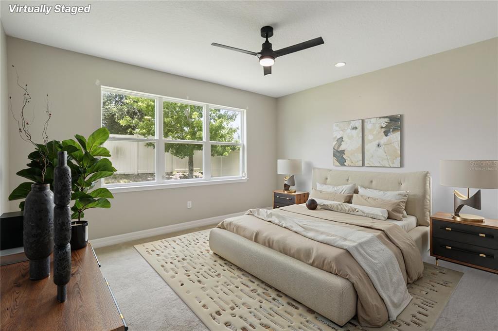 2066 Cresswell Street Ocoee, FL 34761 - Photo 13 of 32 a bedroom with a large bed chandelier and a window