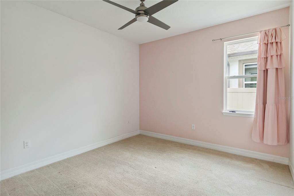 2066 Cresswell Street Ocoee, FL 34761 - Photo 18 of 32 an empty room with a window and a ceiling fan