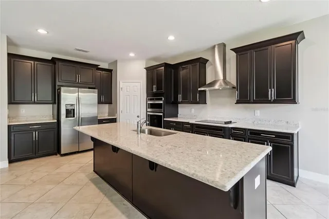 a living room with furniture and a view of kitchen