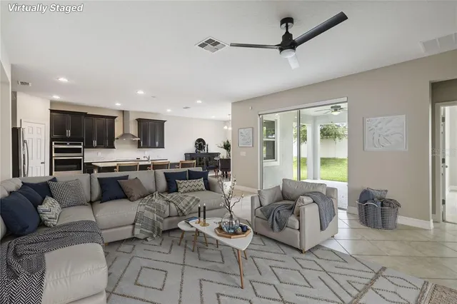 a large kitchen with stainless steel appliances a sink a counter top space cabinets and a view of kitchen