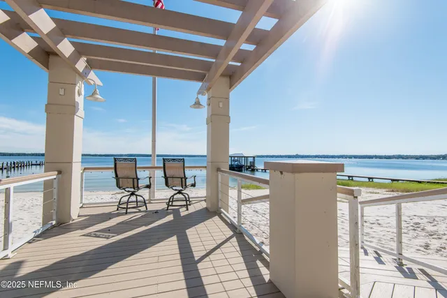 a view of a house with a yard and palm trees