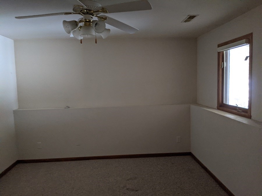 1715 Lake Summerset Road Davis, IL 61019 - Photo 9 of 9 an empty room with a window and a fan