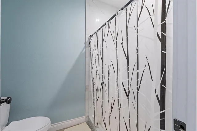 a bathroom with a toilet and shower