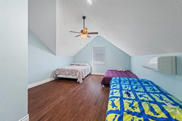a bedroom with bed and a book shelf