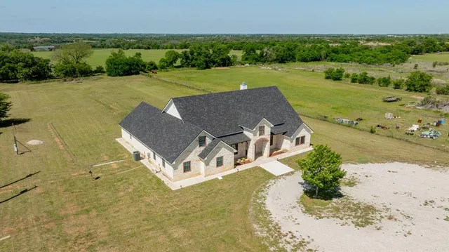 an aerial view of a house with garden space and outdoor space