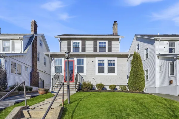a front view of a house with a garden