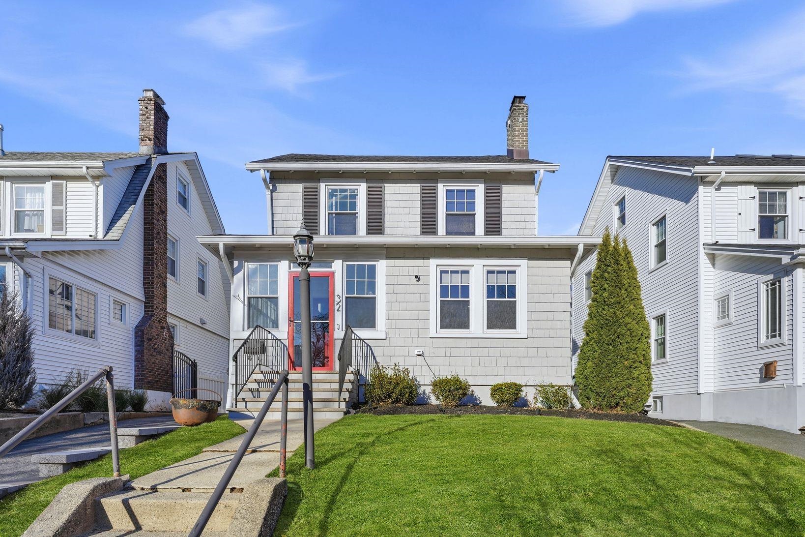 a front view of a house with a garden