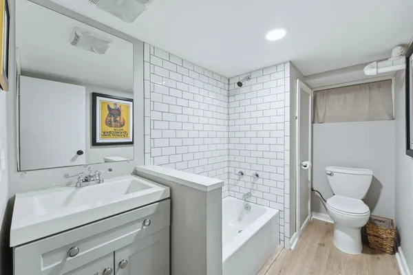 a bathroom with a sink a mirror a vanity and a shower