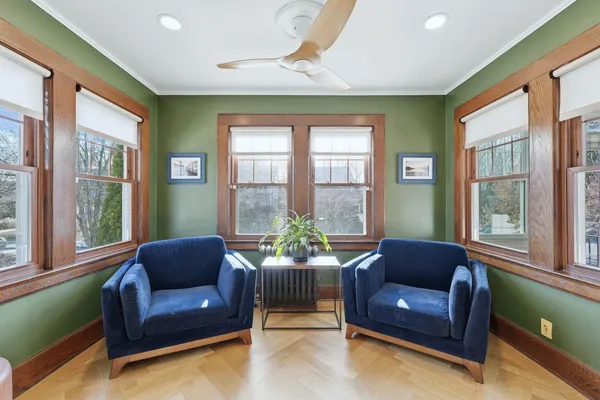 a view of a hallway with wooden floor and staircase