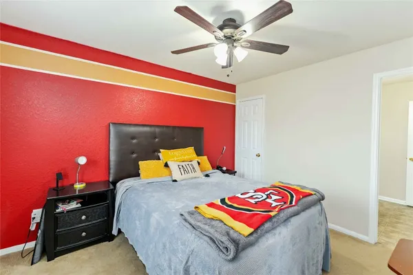 a bedroom with a bed and a lamp