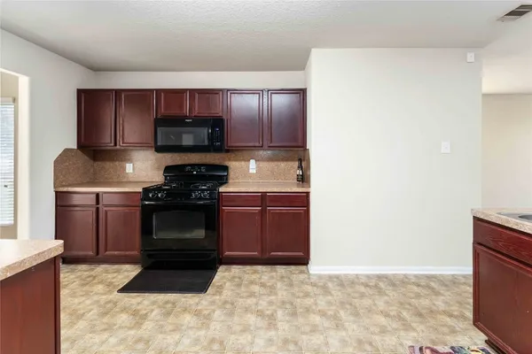 a kitchen with a sink and a stove top oven