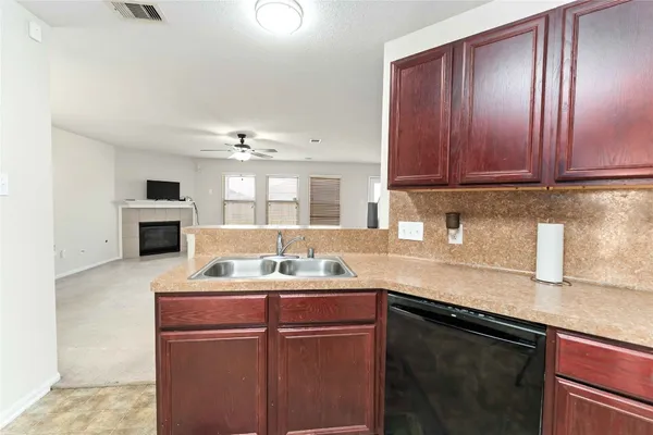 a kitchen with a sink cabinets and stainless steel appliances