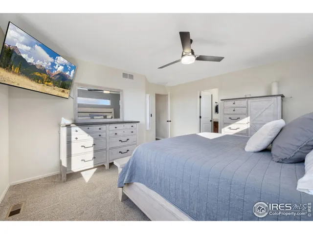 a bedroom with a bed and a ceiling fan