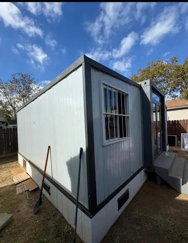 a view of backyard with cabin