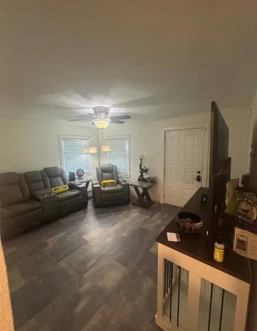 a living room with furniture a flat screen tv and a couch