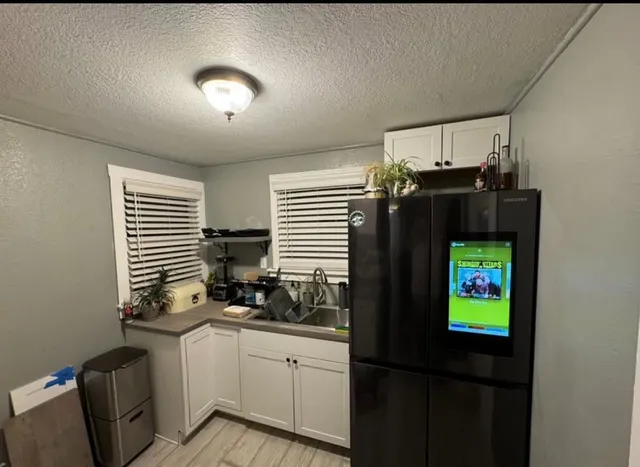 a kitchen with a sink and a refrigerator