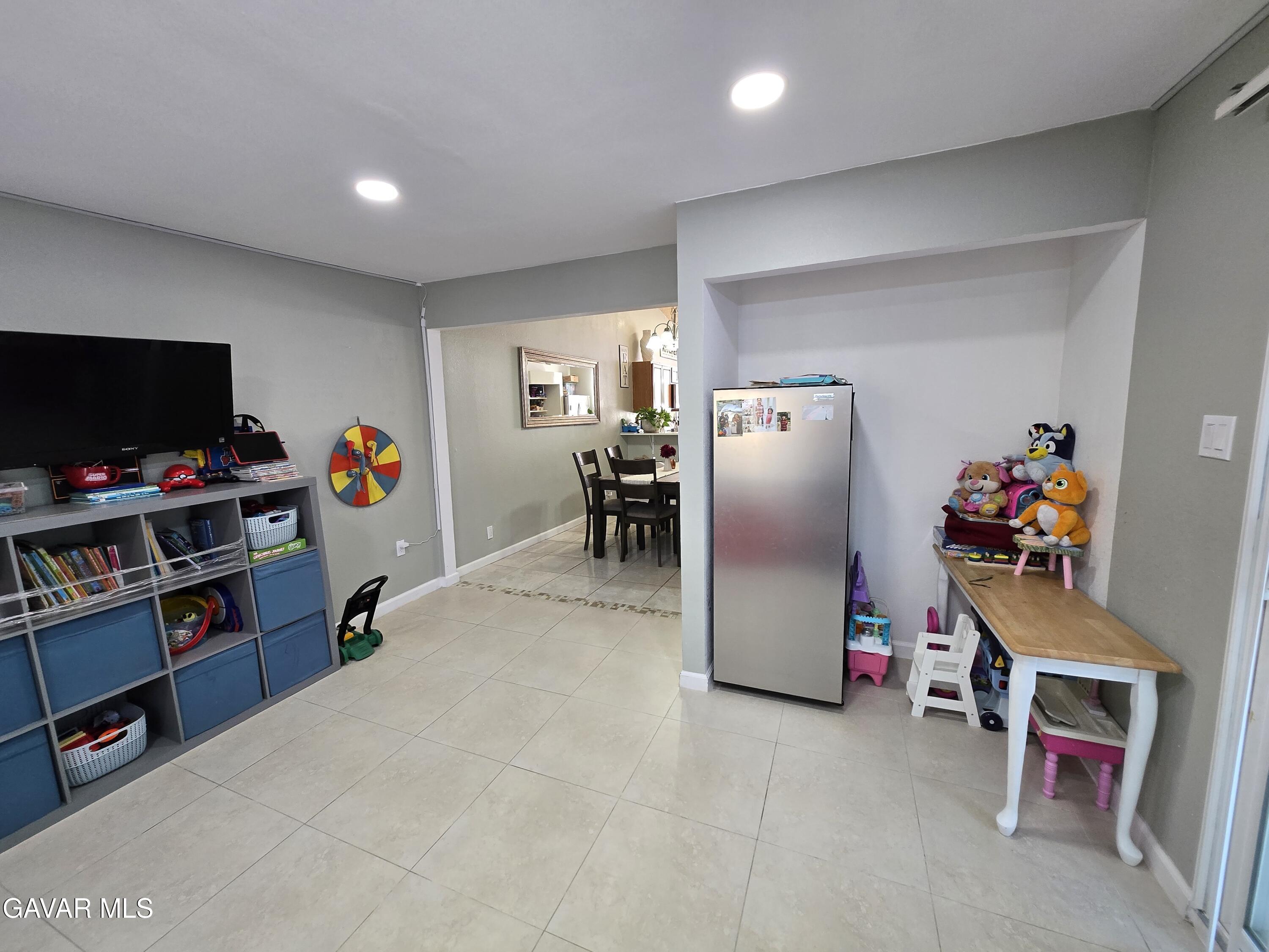3840 Hatcher Place Rosamond, CA 93560 - Photo 14 of 28 a room with furniture and a flat screen tv
