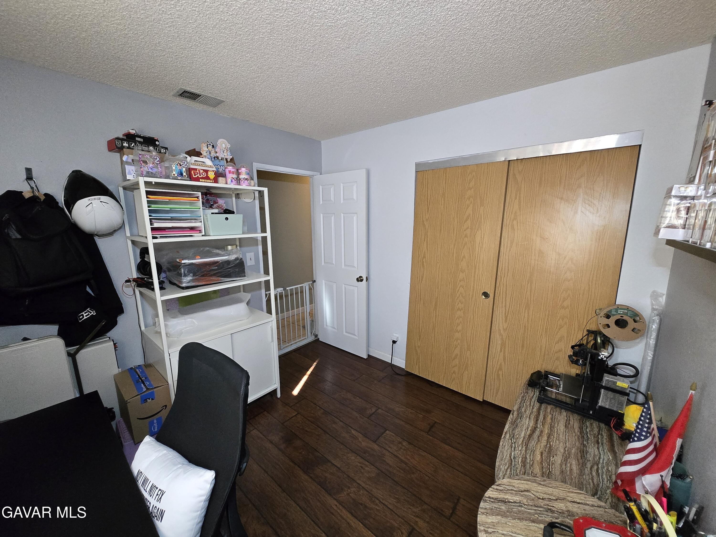 3840 Hatcher Place Rosamond, CA 93560 - Photo 16 of 28 a view of workspace with furniture and wooden floor