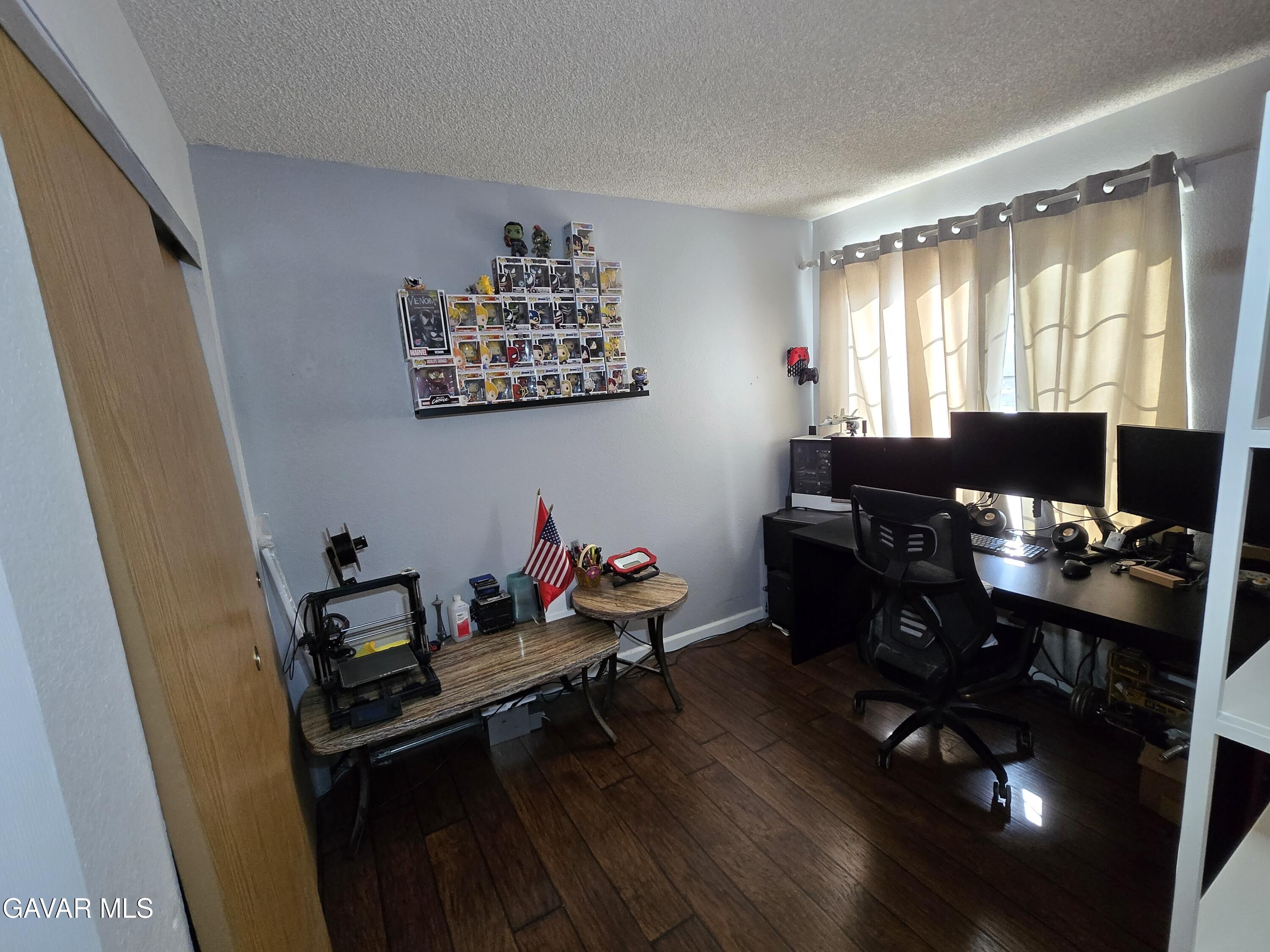 3840 Hatcher Place Rosamond, CA 93560 - Photo 17 of 28 a view of a workspace with furniture and a window