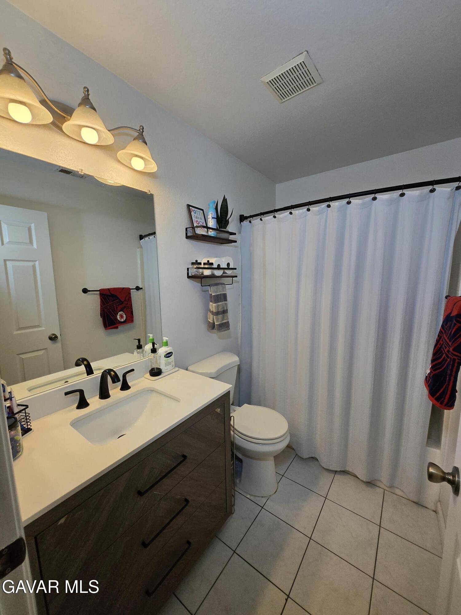 3840 Hatcher Place Rosamond, CA 93560 - Photo 19 of 28 a bathroom with a sink toilet and shower