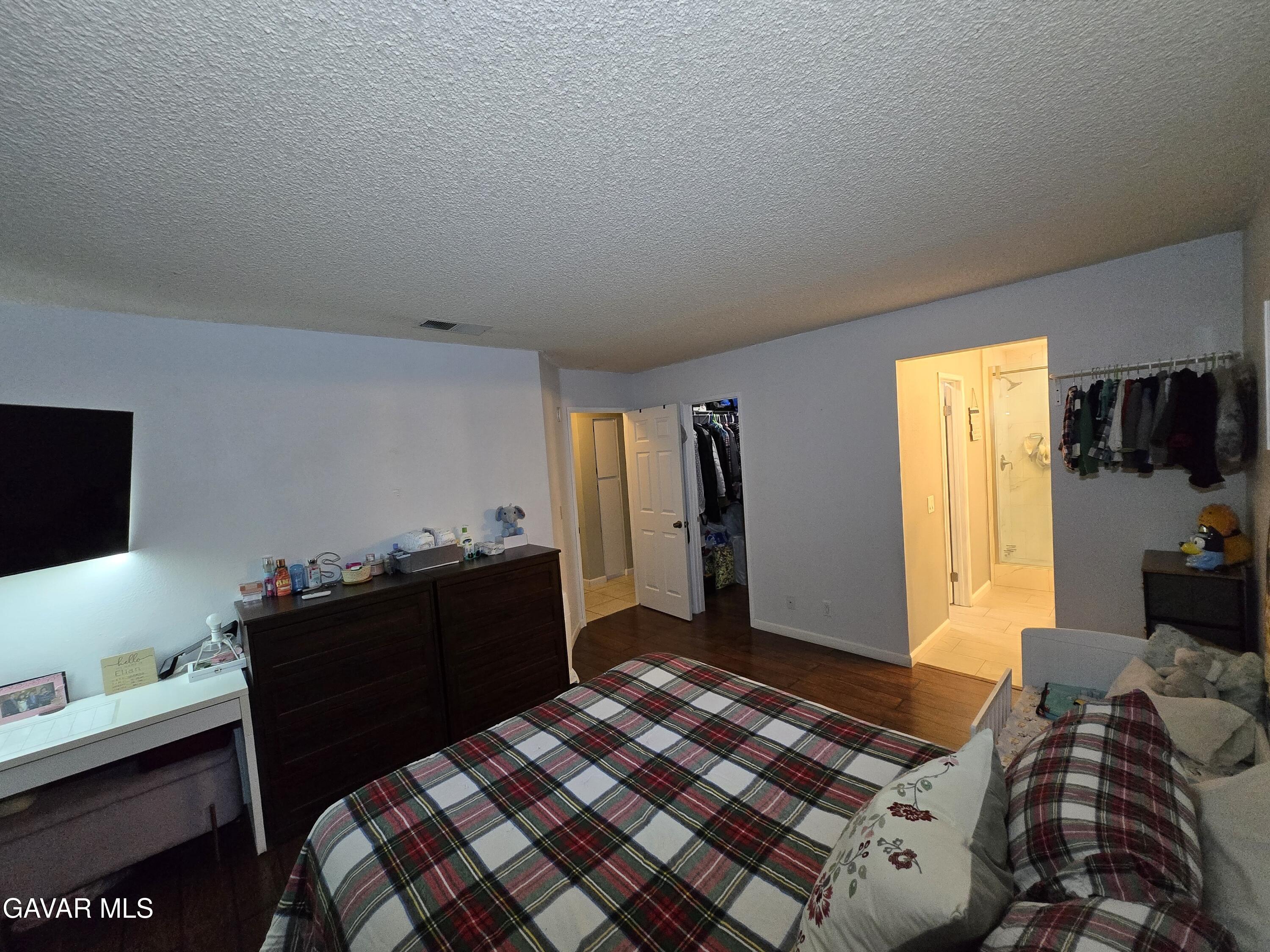 3840 Hatcher Place Rosamond, CA 93560 - Photo 21 of 28 a bedroom with a bed and flat screen tv