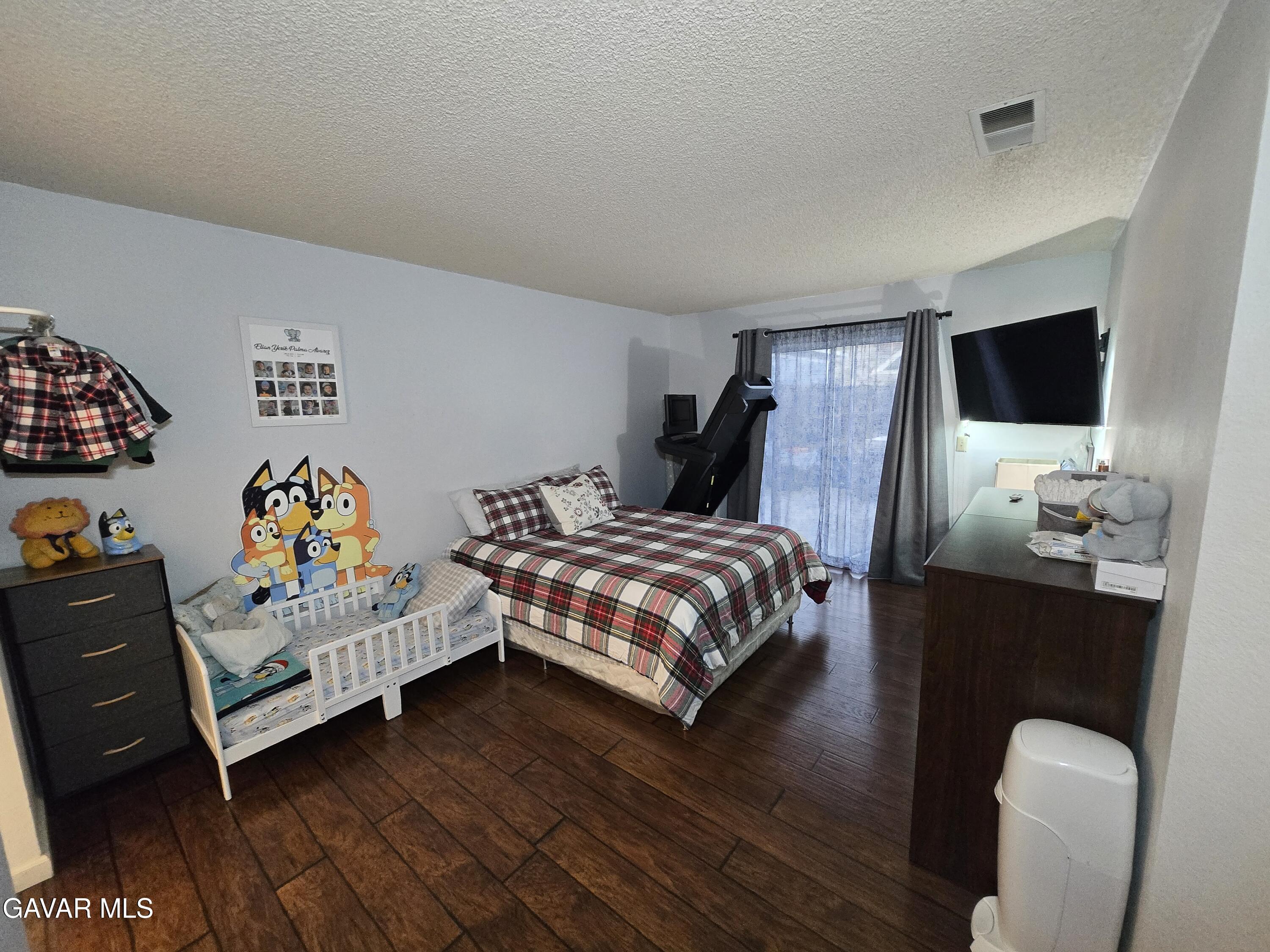 3840 Hatcher Place Rosamond, CA 93560 - Photo 23 of 28 a bedroom with a bed and a flat screen tv