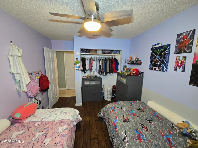 a bedroom that has a bed and a chandelier
