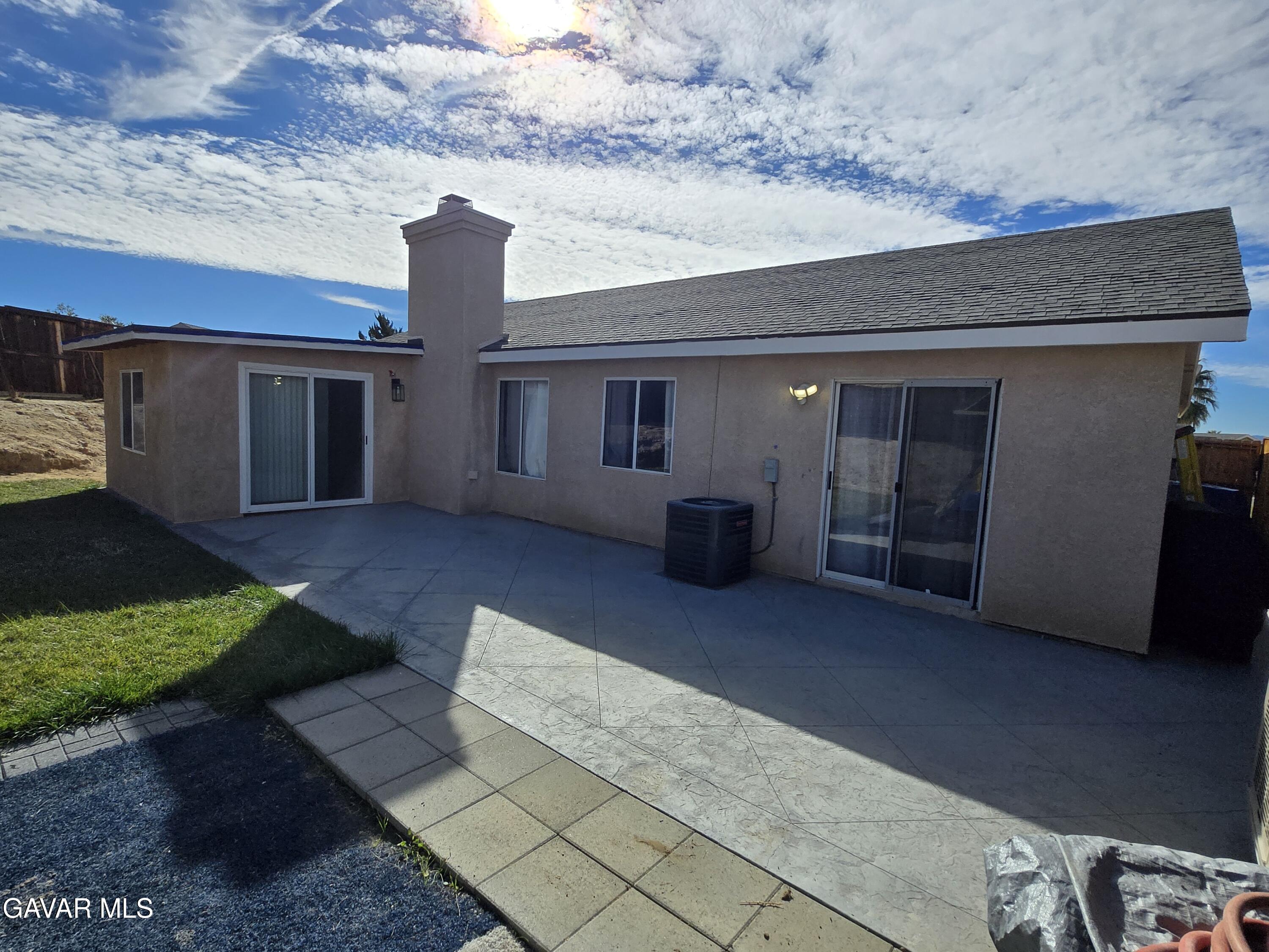 3840 Hatcher Place Rosamond, CA 93560 - Photo 26 of 28 a front view of a house with yard