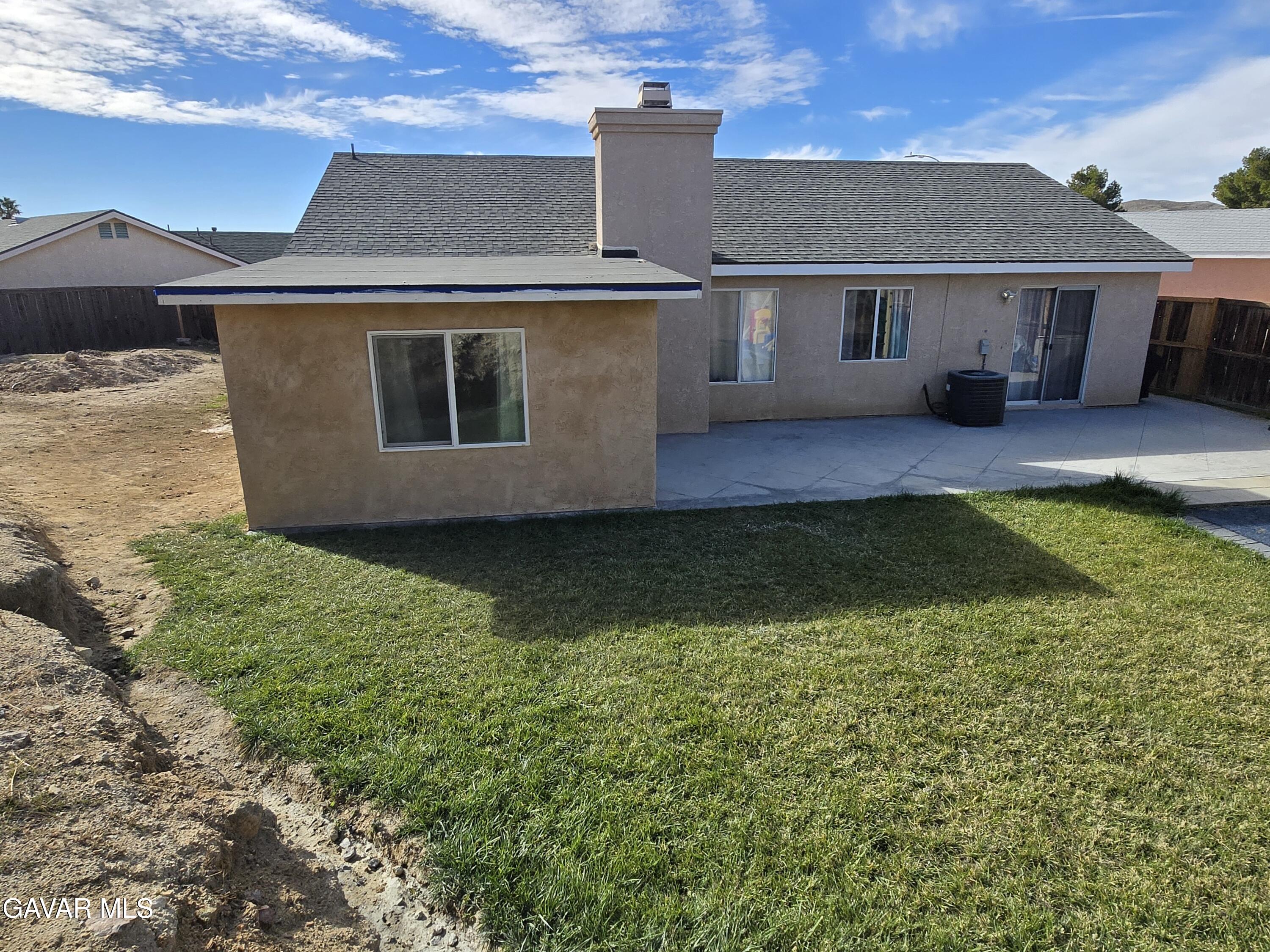 3840 Hatcher Place Rosamond, CA 93560 - Photo 27 of 28 a view of a house with a yard
