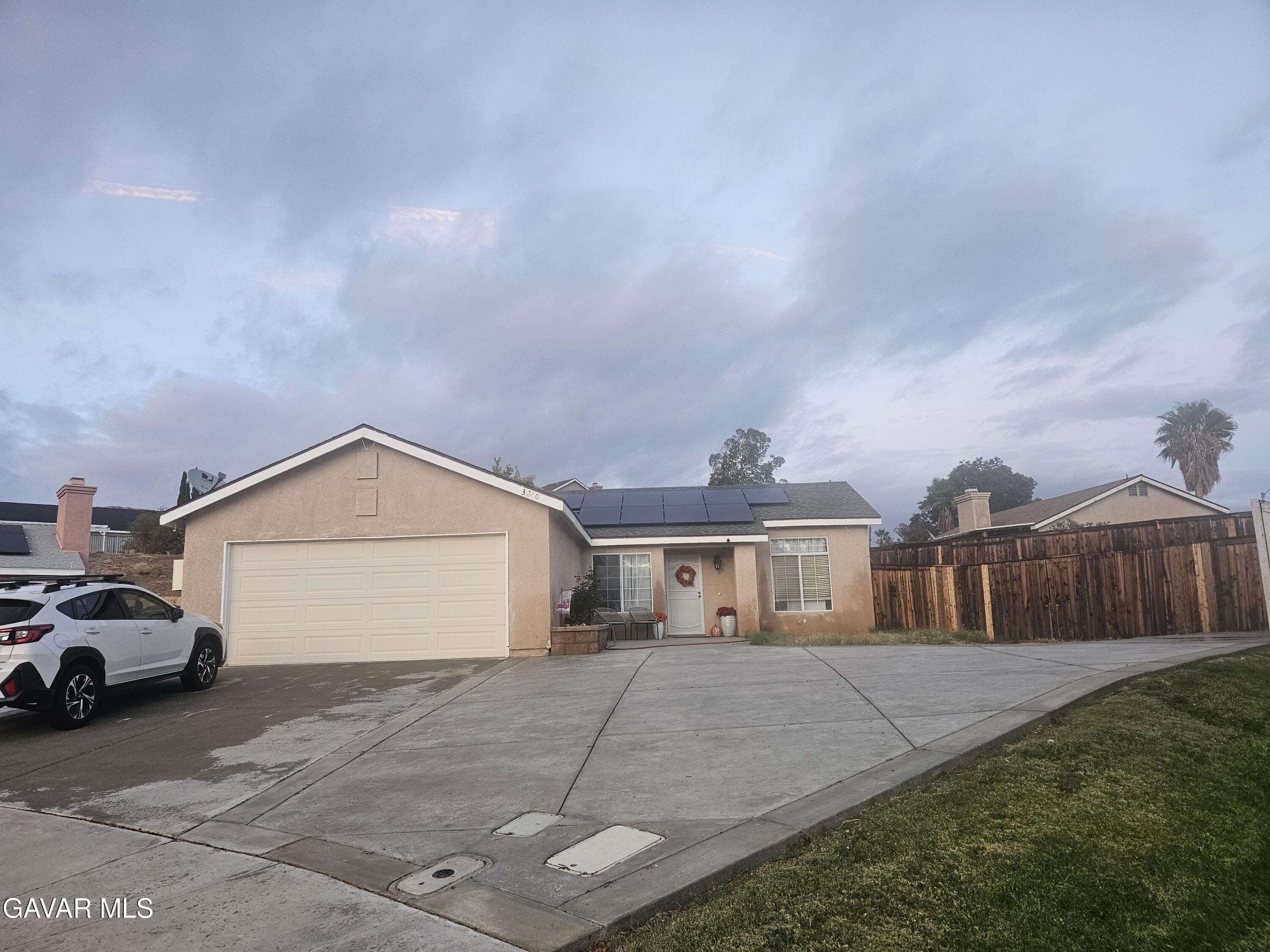 3840 Hatcher Place Rosamond, CA 93560 - Photo 3 of 28 a front view of a house with a garden