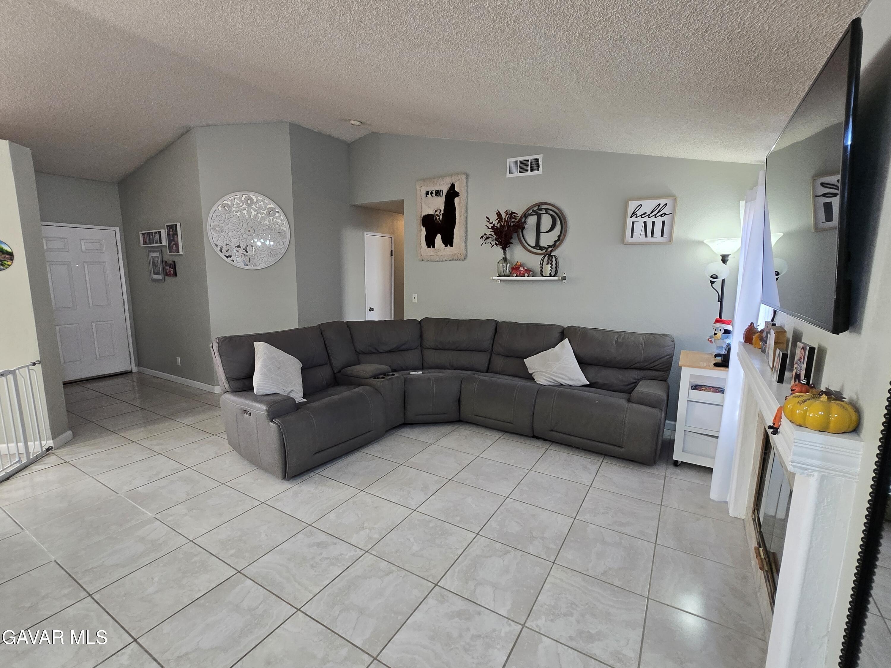 3840 Hatcher Place Rosamond, CA 93560 - Photo 5 of 28 a living room with furniture and a flat screen tv