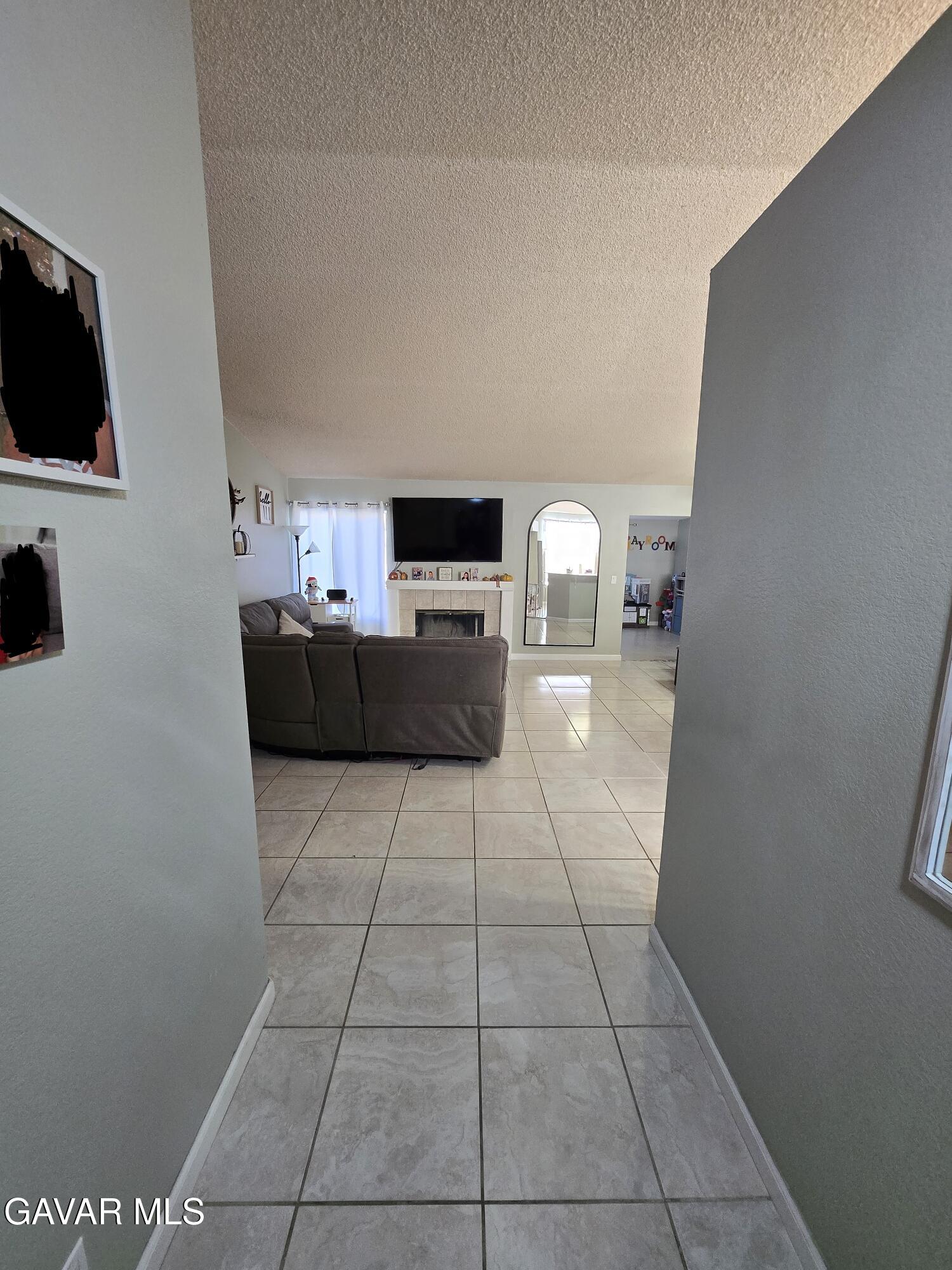 3840 Hatcher Place Rosamond, CA 93560 - Photo 7 of 28 a living room with furniture and a flat screen tv