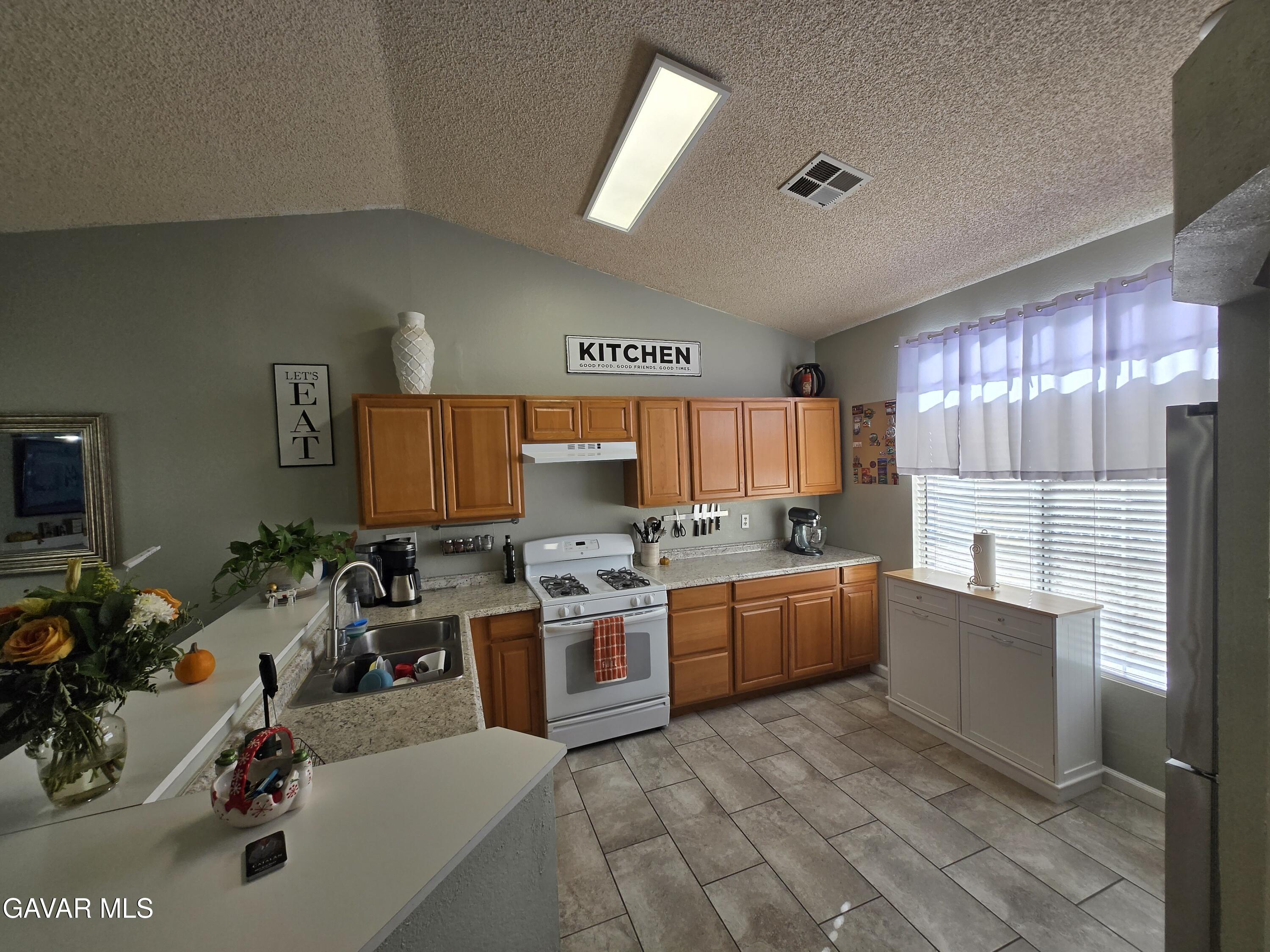 3840 Hatcher Place Rosamond, CA 93560 - Photo 10 of 28 a kitchen with a sink appliances and cabinets