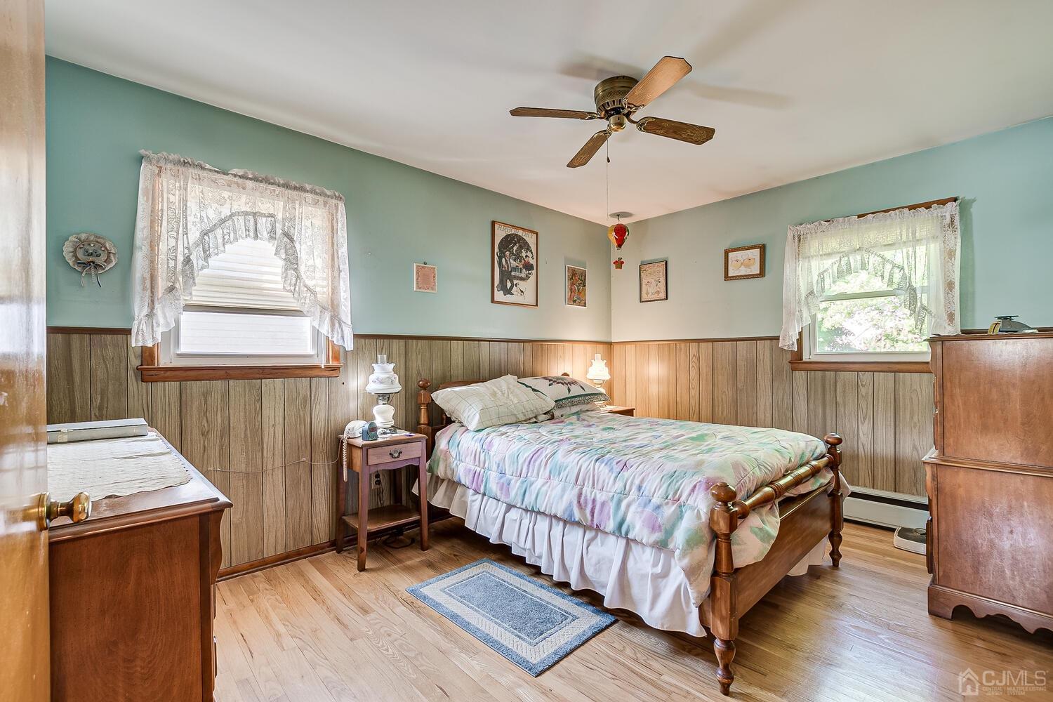 238 Suttons Lane Edison, NJ 08817 - Photo 11 of 21 a bedroom with a bed and a refrigerator