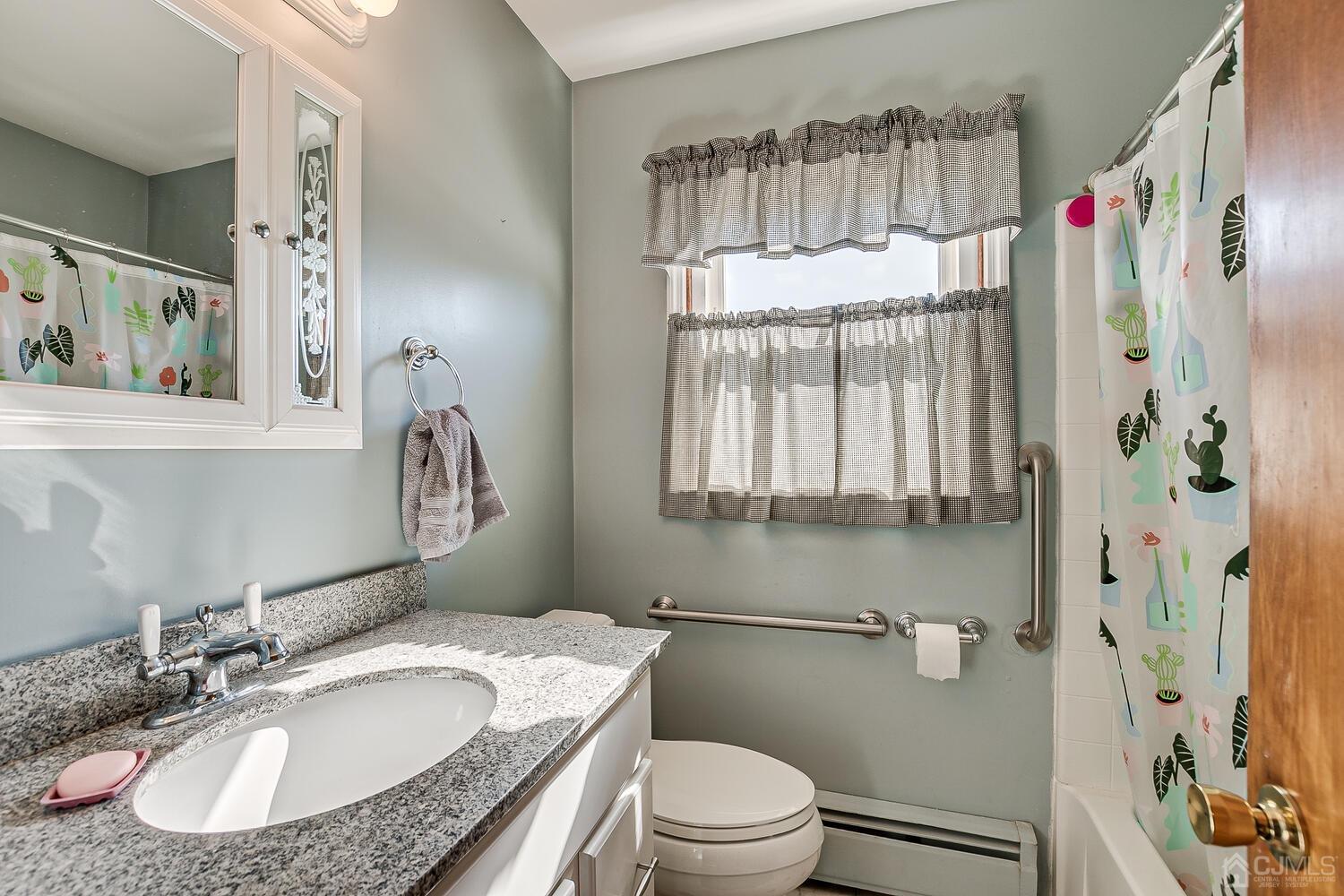 238 Suttons Lane Edison, NJ 08817 - Photo 16 of 21 a bathroom with a granite countertop sink and a mirror