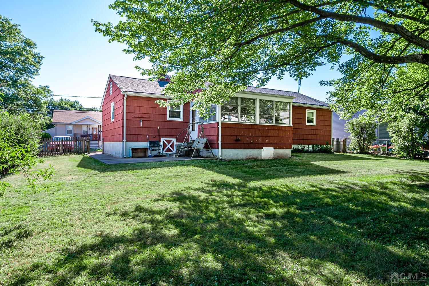 238 Suttons Lane Edison, NJ 08817 - Photo 19 of 21 a front view of a house with a yard and trees