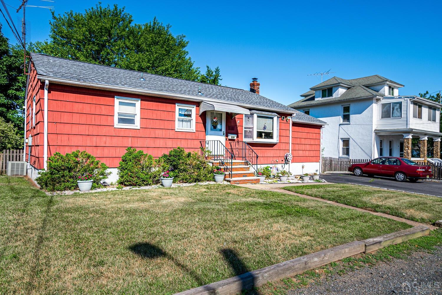238 Suttons Lane Edison, NJ 08817 - Photo 2 of 21 a front view of a house with a yard