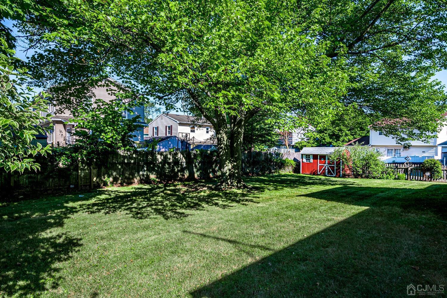 238 Suttons Lane Edison, NJ 08817 - Photo 21 of 21 a backyard of a house with lots of green space and fountain
