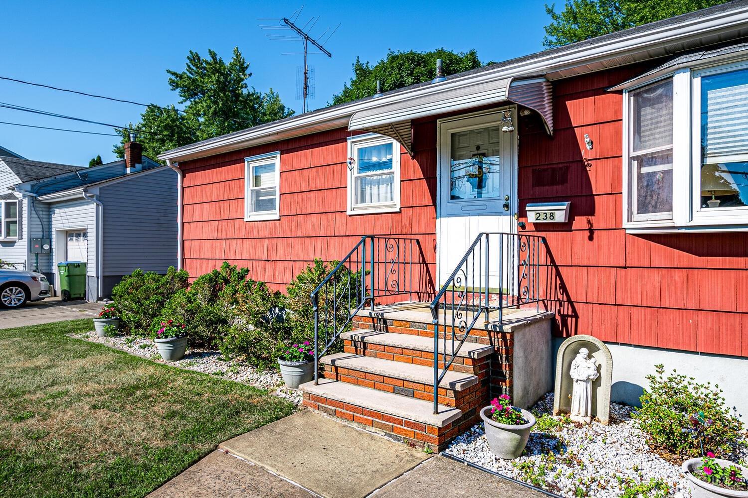 238 Suttons Lane Edison, NJ 08817 - Photo 3 of 21 a front view of a house with a yard