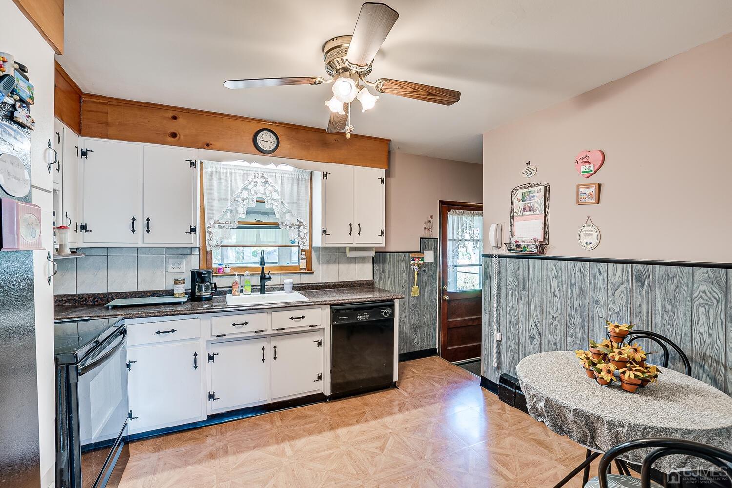 238 Suttons Lane Edison, NJ 08817 - Photo 6 of 21 a kitchen with stainless steel appliances granite countertop a stove a sink dishwasher and white cabinets with wooden floor