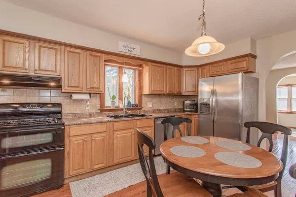 a dining room with furniture and wooden floor