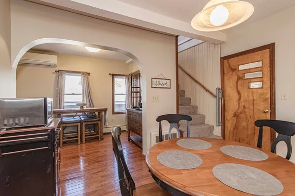 a kitchen with stainless steel appliances granite countertop a sink a stove a refrigerator a dining table and chairs