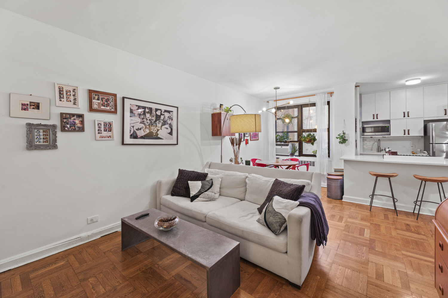 345 Riverside Drive, Unit 4F Manhattan, NY 10025 - Photo 2 of 9 a living room with furniture and a large window