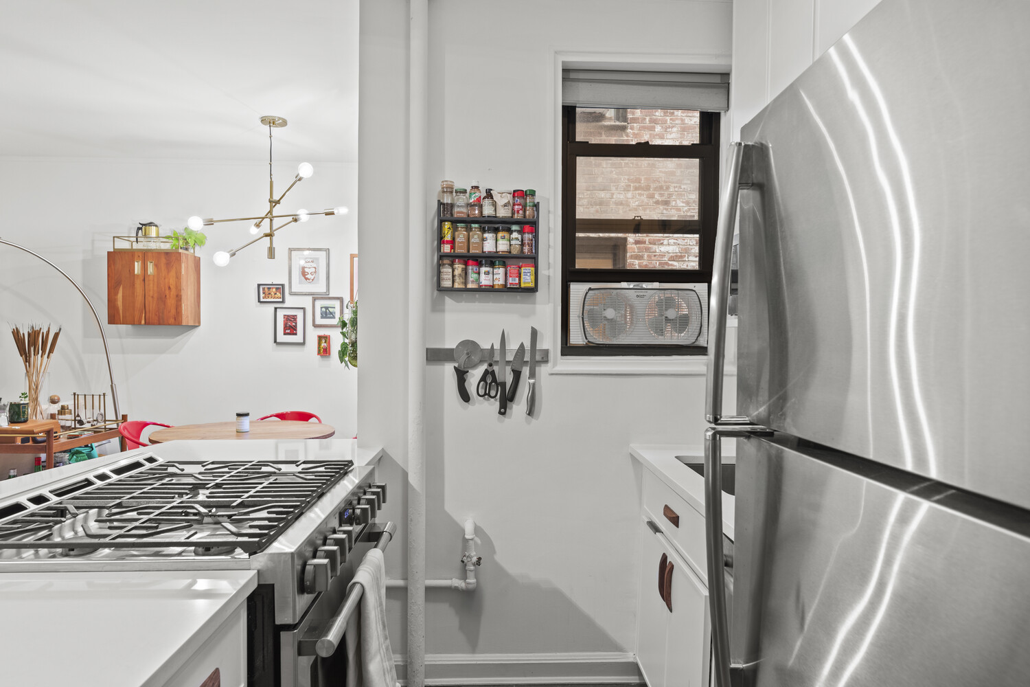 345 Riverside Drive, Unit 4F Manhattan, NY 10025 - Photo 4 of 9 a kitchen with stainless steel appliances granite countertop a refrigerator and a stove top oven