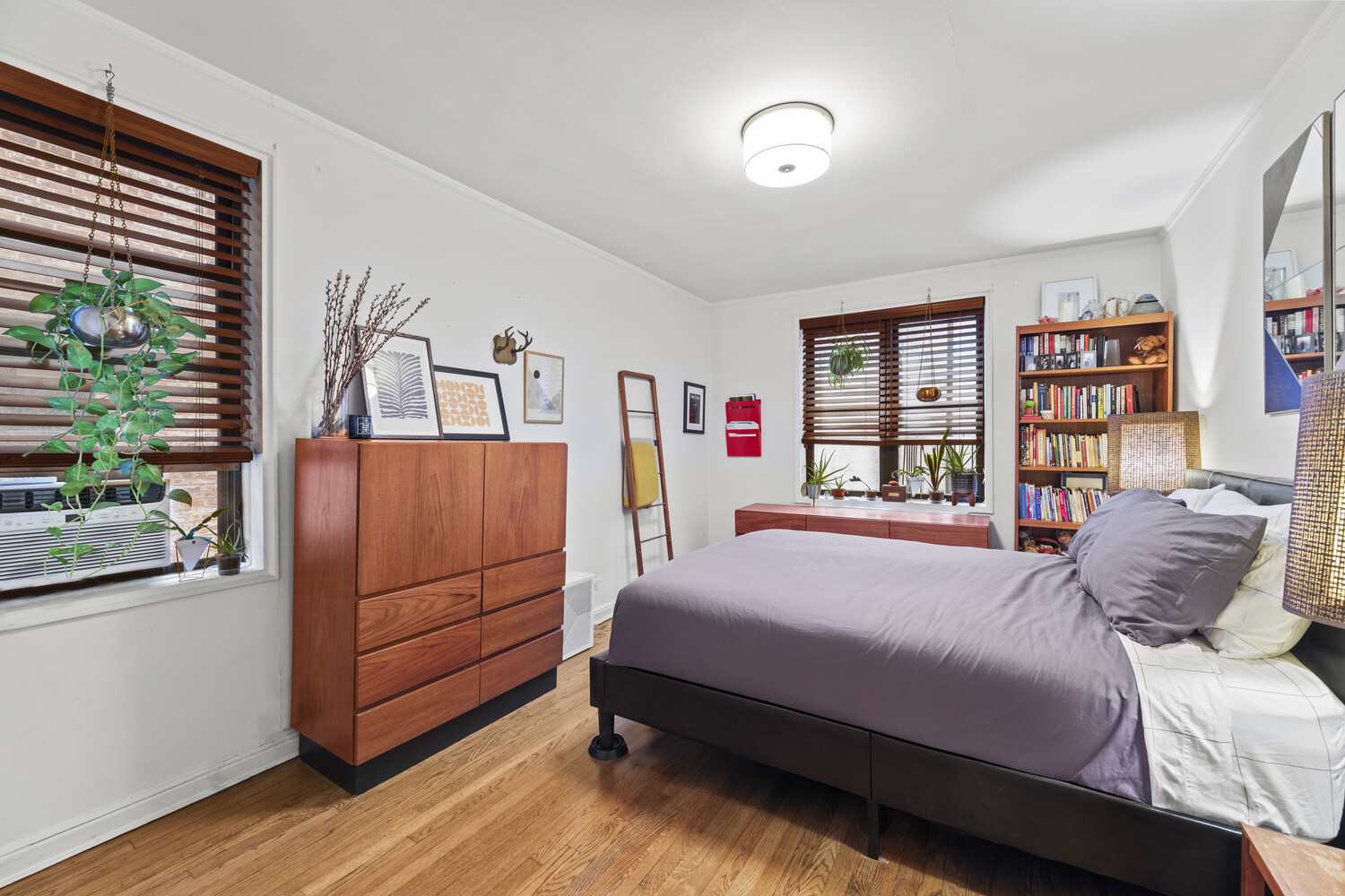 345 Riverside Drive, Unit 4F Manhattan, NY 10025 - Photo 8 of 9 a bedroom with a bed cabinets and window