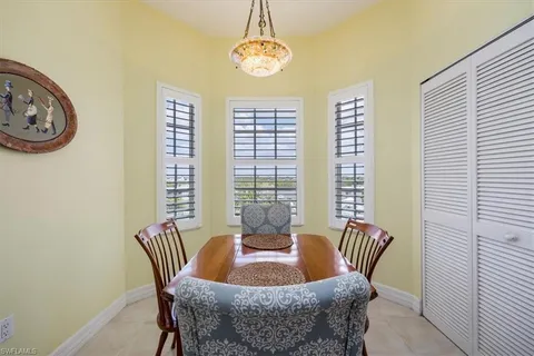a dining room with furniture and window