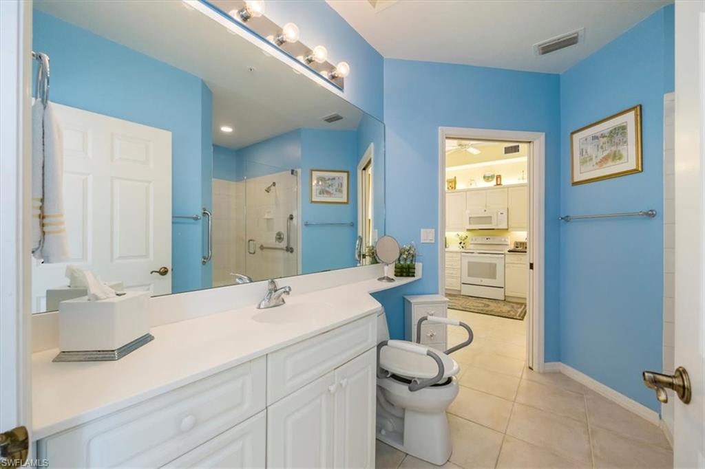 401 Bayfront Place, Unit 3509 Naples, FL 34102 - Photo 9 of 21 a bathroom with a granite countertop sink mirror and toilet