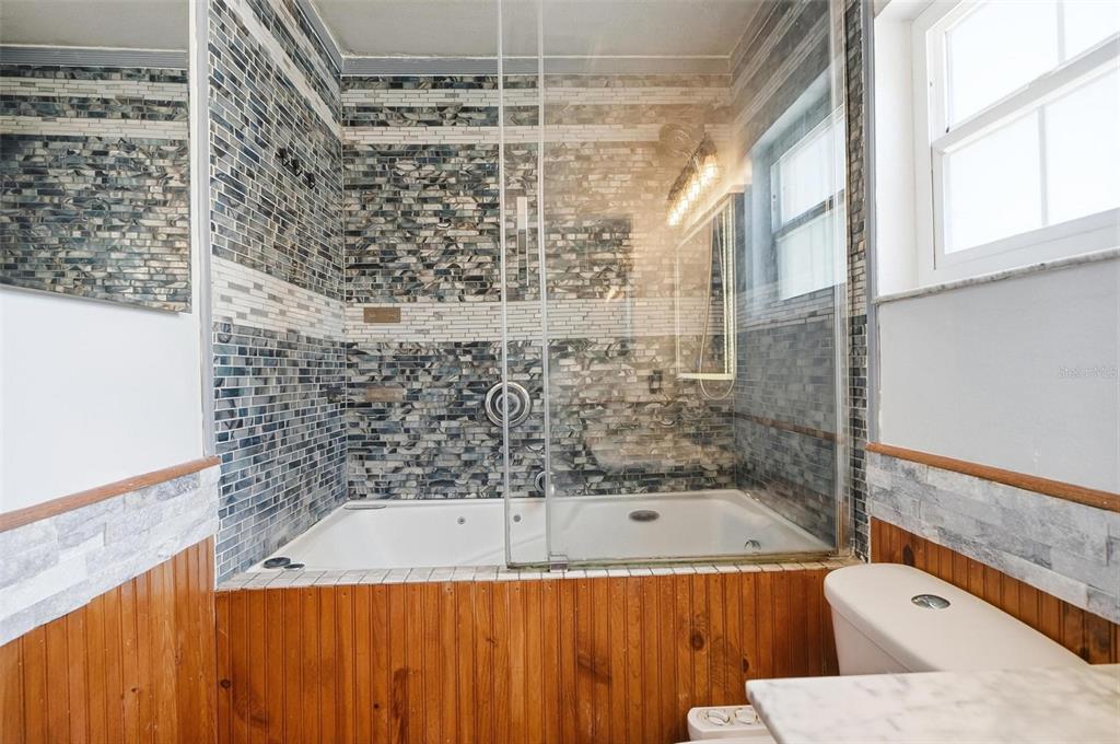 1071 Angora Street Deltona, FL 32725 - Photo 14 of 45 a bathroom with a bathtub and shower