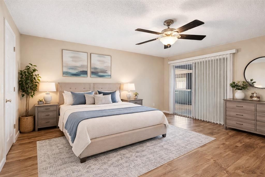 1071 Angora Street Deltona, FL 32725 - Photo 16 of 45 a spacious bedroom with a large bed and a chandelier