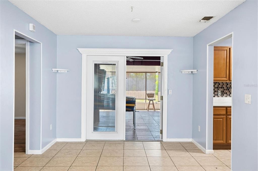 1071 Angora Street Deltona, FL 32725 - Photo 17 of 45 a view of a hallway with wooden floor and a living room